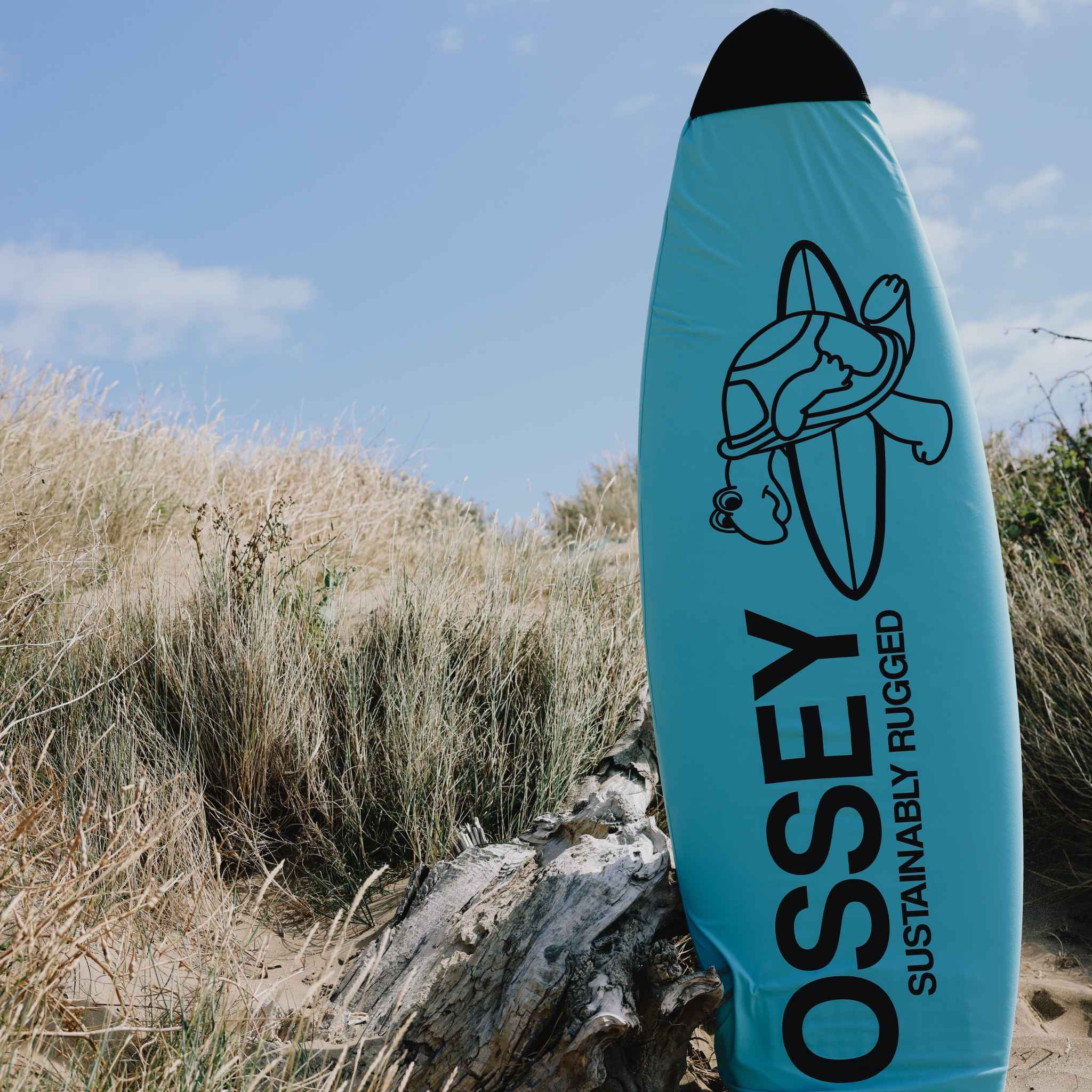 Blue surfboard sock with 'OSSEY' branding on a beach